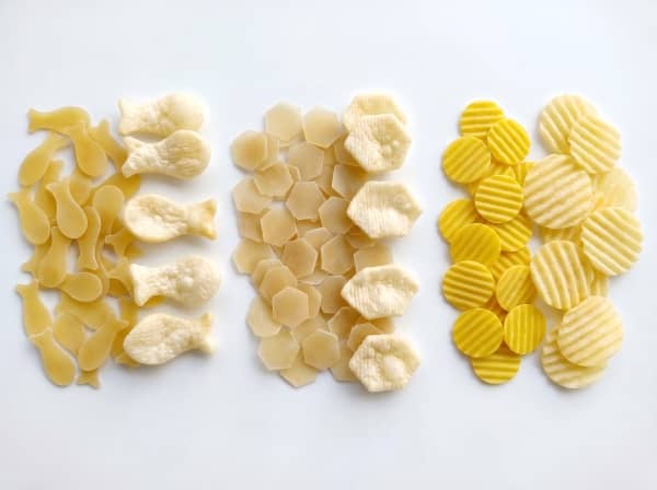Extruded 2D snack pellets including starch-based shells, spirals, and wavy chips.