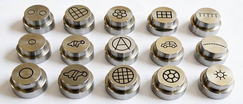 Custom stainless steel extrusion dies for shaping 2D and 3D snack pellets.